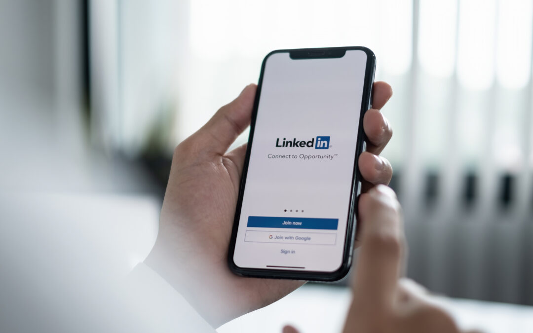 A man logs in to LinkedIn on his phone.